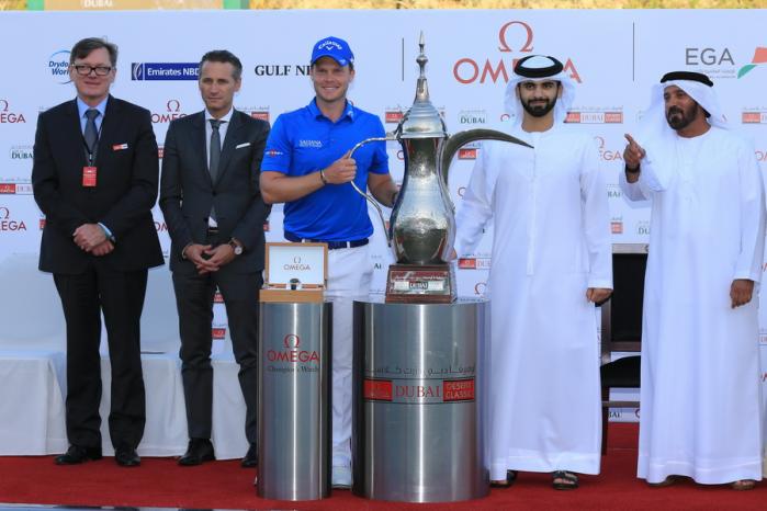 Danny Willett /England is presented with the trophy by Sheikh Mansoor bin Mohammed bin Rashid al-Maktoum